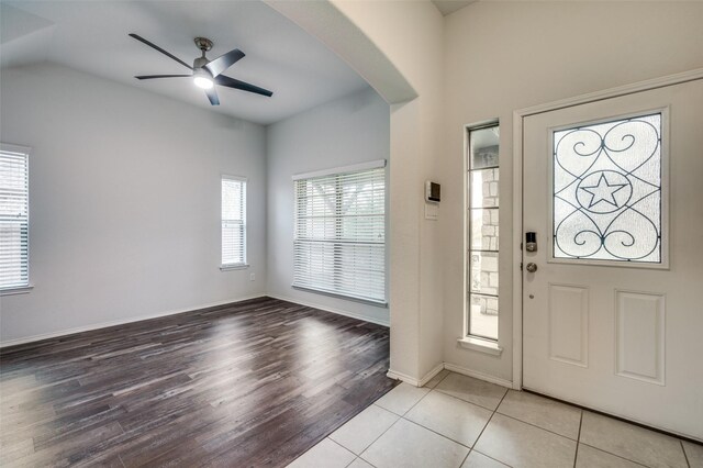 entrance foyer featuring lofted ceiling, light tile patterned floors, and ceiling fan