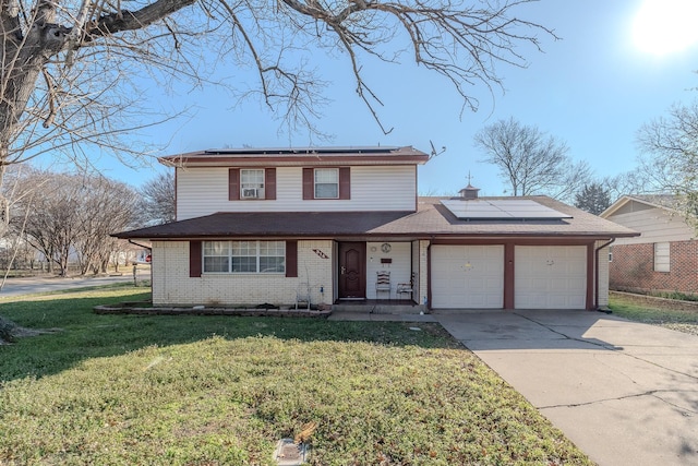 front of property featuring a garage, a front lawn, and solar panels