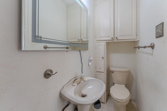 bathroom featuring tile patterned flooring, sink, and toilet