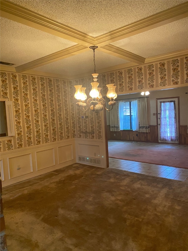 unfurnished dining area with a textured ceiling, a notable chandelier, and dark carpet