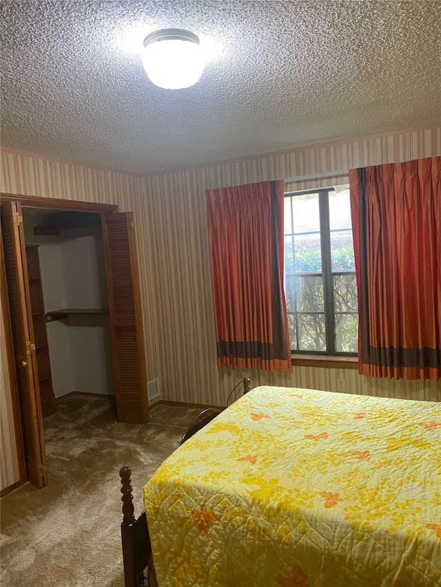 unfurnished bedroom with carpet floors and a textured ceiling