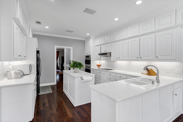 kitchen featuring white cabinetry, crown molding, decorative light fixtures, and dark hardwood / wood-style floors