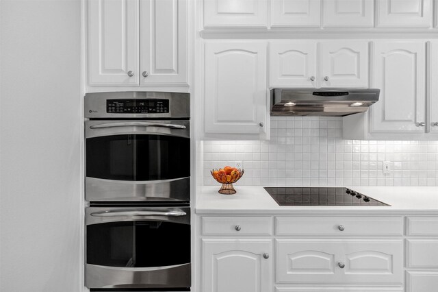 kitchen with pendant lighting, sink, dishwasher, and white cabinets