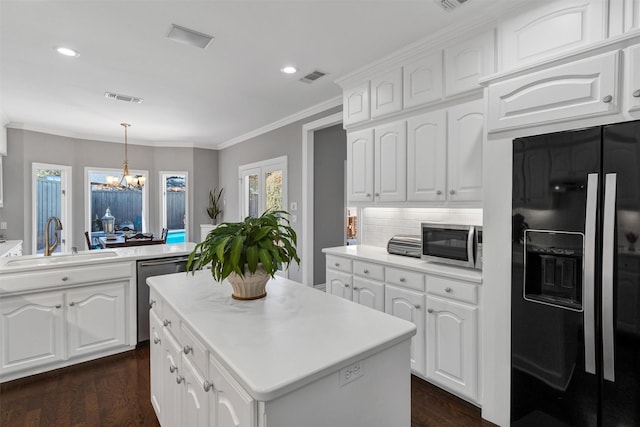 kitchen with visible vents, appliances with stainless steel finishes, dark wood-style flooring, and a sink