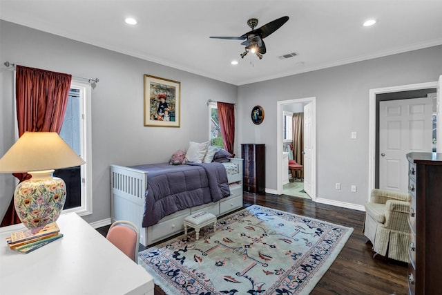 bedroom featuring ornamental molding, ceiling fan, dark hardwood / wood-style flooring, and ensuite bath