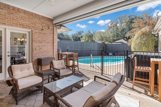 view of patio with outdoor lounge area and a fenced in pool