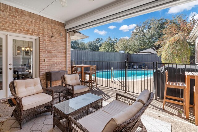 view of pool with a lawn and a patio