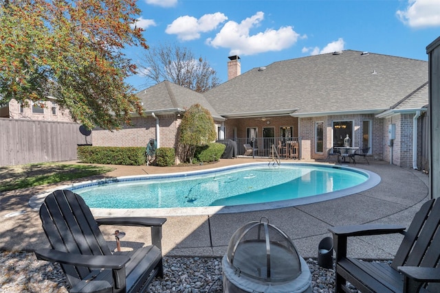 view of swimming pool featuring a patio area, fence, and a fenced in pool