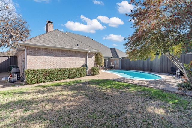 view of pool with a fenced in pool, a patio area, a fenced backyard, and a yard