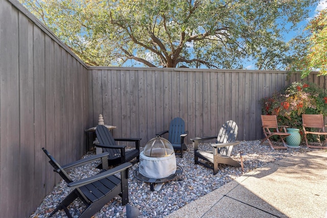 view of patio featuring an outdoor fire pit and a fenced backyard