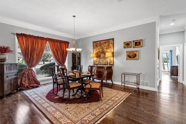 dining space featuring crown molding, dark hardwood / wood-style floors, and a notable chandelier