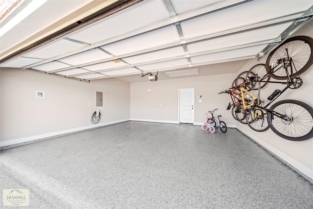 garage featuring a garage door opener and electric panel