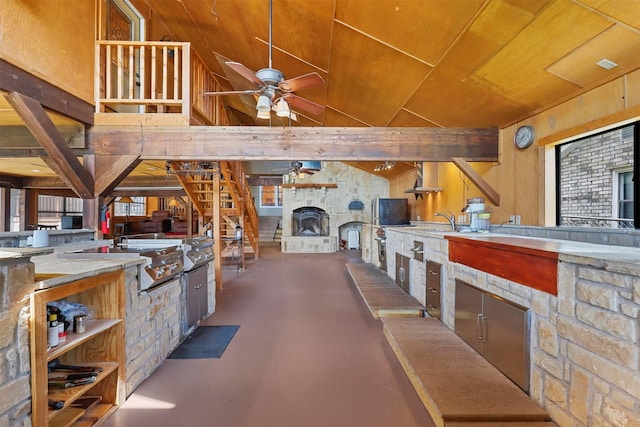 stairs featuring a wealth of natural light, concrete flooring, ceiling fan, and vaulted ceiling