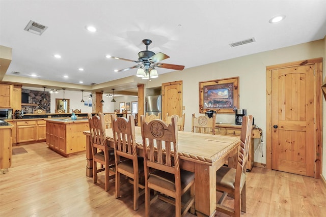 living room featuring light hardwood / wood-style flooring and ceiling fan