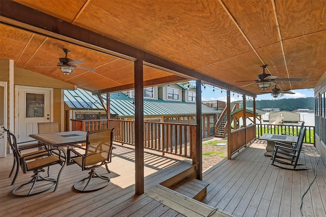 rear view of house featuring a water view, a yard, and covered porch