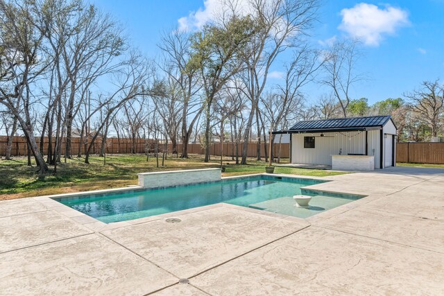 rear view of property with a swimming pool with hot tub, a patio, and a yard