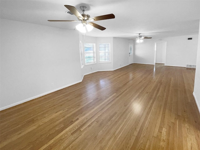 empty room featuring ceiling fan and hardwood / wood-style floors