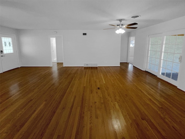 unfurnished living room featuring ceiling fan and dark hardwood / wood-style flooring