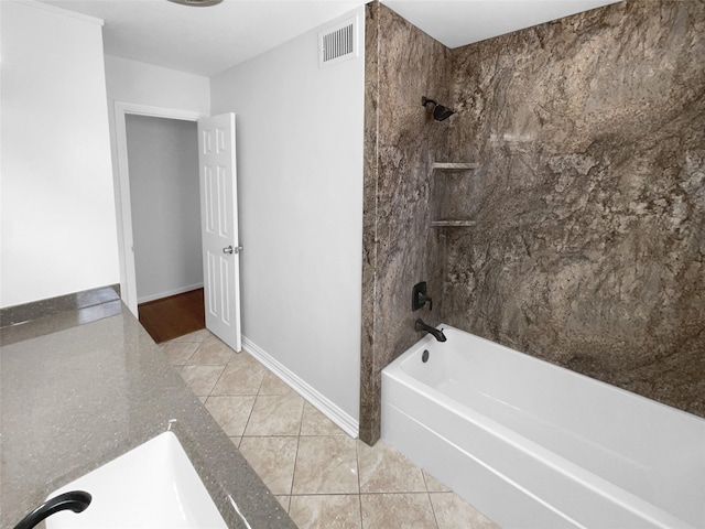 bathroom featuring tiled shower / bath, sink, and tile patterned flooring