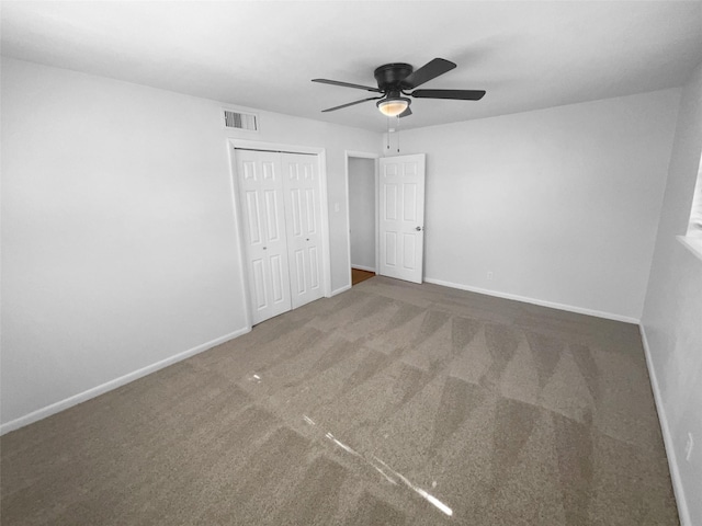 unfurnished bedroom featuring a closet, ceiling fan, and dark colored carpet