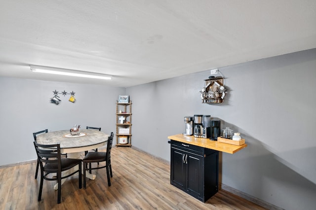 dining space with hardwood / wood-style floors