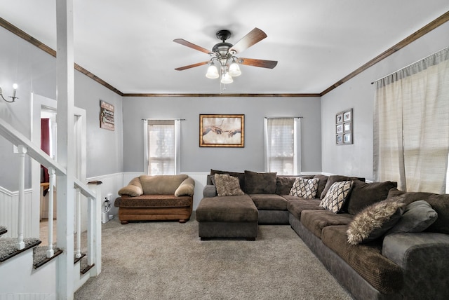 living room with crown molding, light colored carpet, and ceiling fan