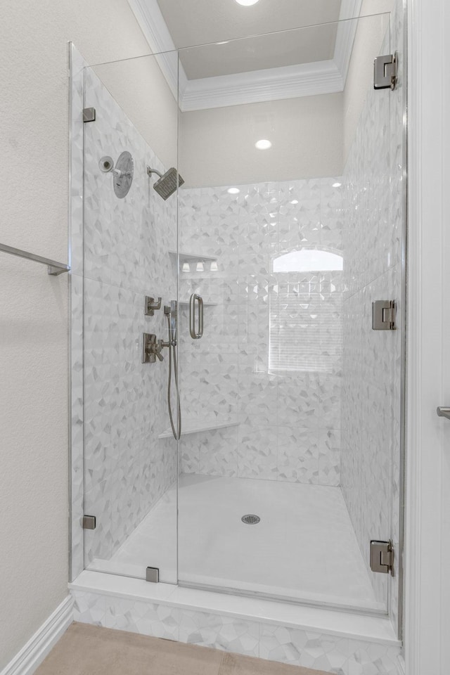 bathroom with crown molding and an enclosed shower