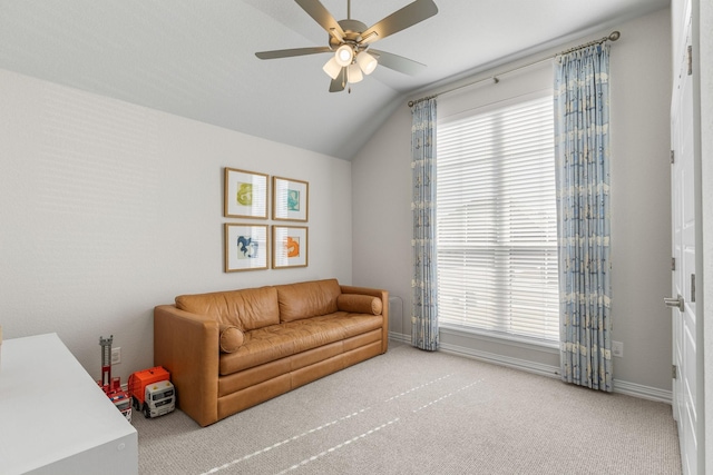 carpeted living room featuring vaulted ceiling and ceiling fan