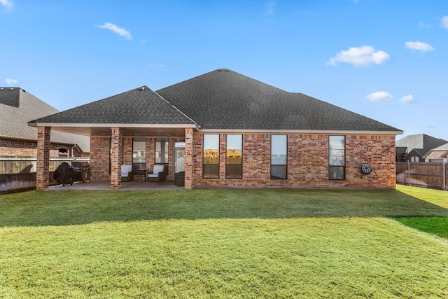 back of property featuring a yard and a patio area