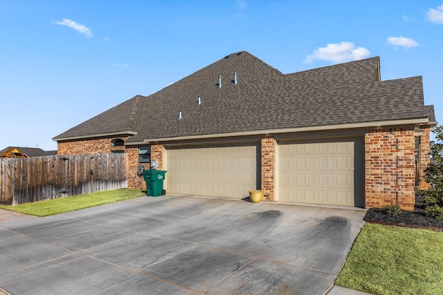 view of side of home with a yard and a garage