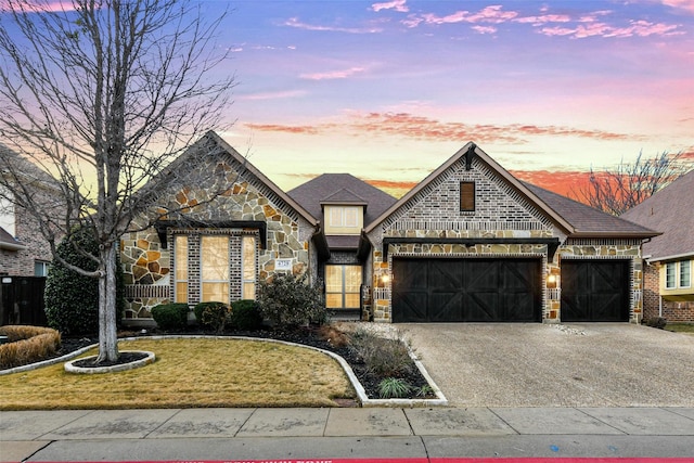 view of front of home featuring a garage and a yard