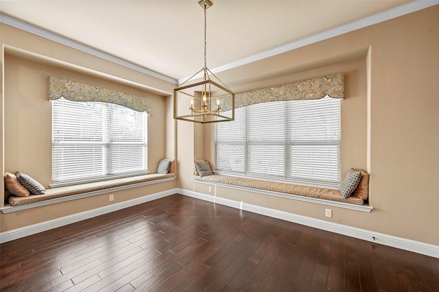 unfurnished dining area with dark hardwood / wood-style flooring, crown molding, and a chandelier