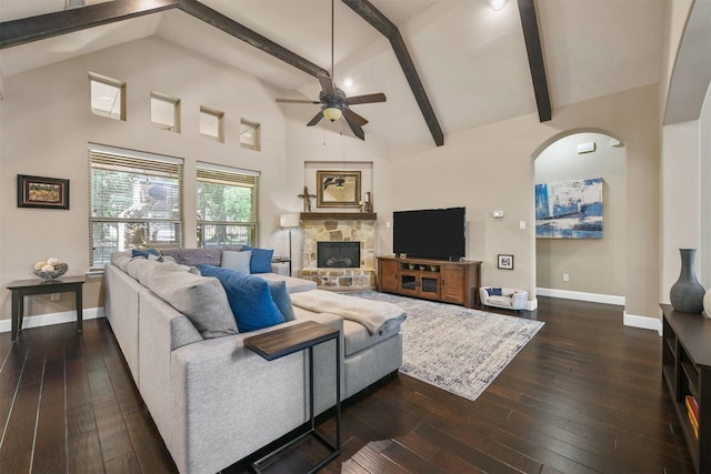 living room with dark hardwood / wood-style floors, high vaulted ceiling, a fireplace, beamed ceiling, and ceiling fan