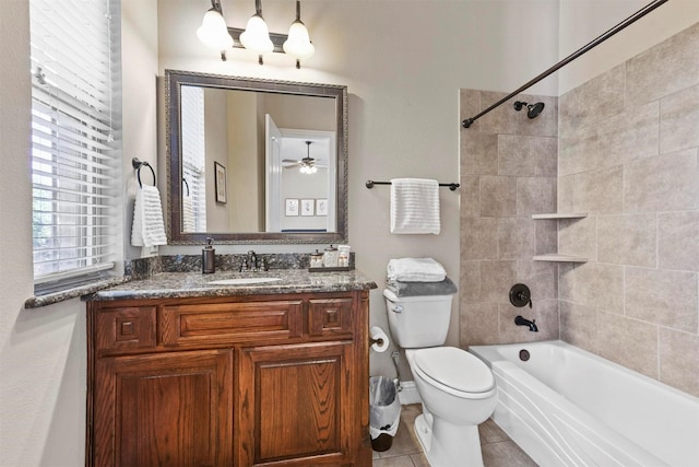 full bathroom with tiled shower / bath, vanity, tile patterned floors, and toilet