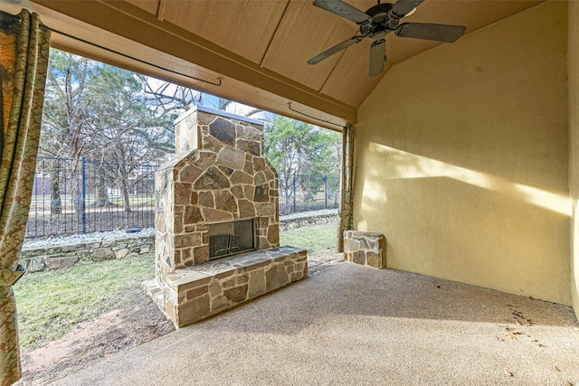 view of patio / terrace featuring ceiling fan and an outdoor stone fireplace