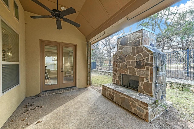 view of patio / terrace with ceiling fan, french doors, and an outdoor stone fireplace