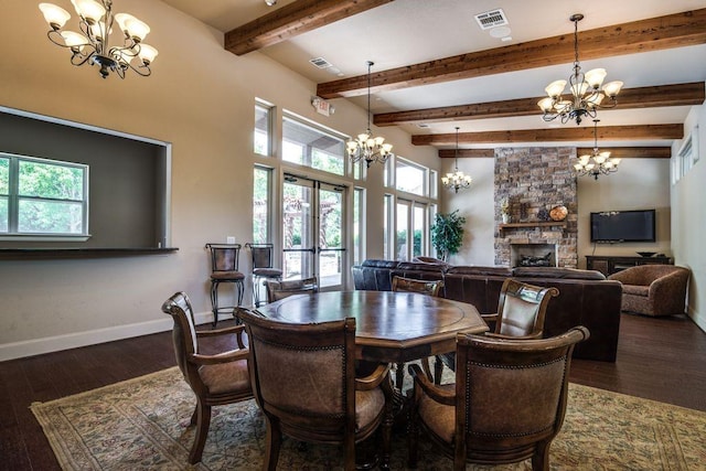 dining space with french doors, dark hardwood / wood-style floors, a stone fireplace, and a notable chandelier