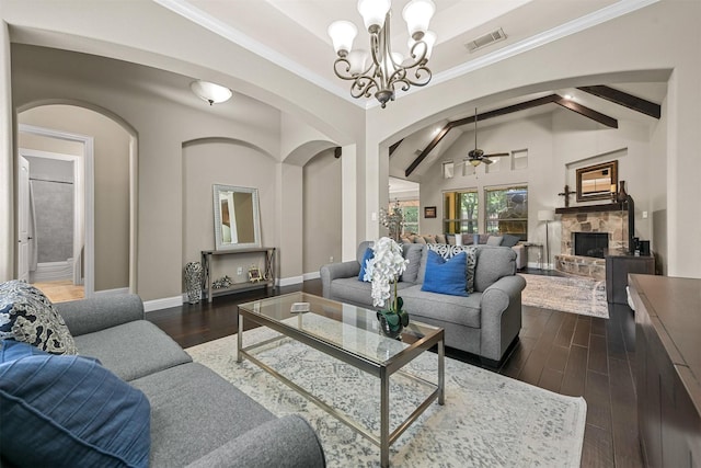 living room featuring ornamental molding, dark hardwood / wood-style flooring, beamed ceiling, a fireplace, and ceiling fan with notable chandelier