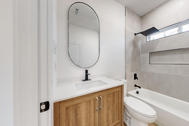 full bathroom with vanity, toilet, and tiled shower / bath