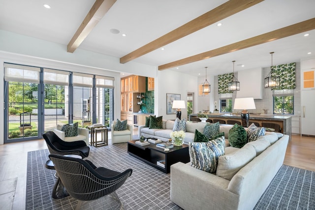 living room featuring a wealth of natural light and beam ceiling