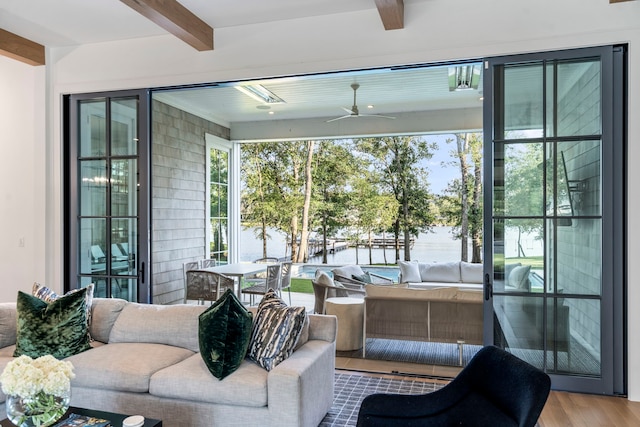 interior space featuring a water view, ceiling fan, and beam ceiling