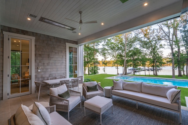 view of patio with an outdoor hangout area, ceiling fan, and a water view