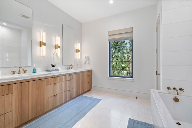 bathroom featuring vanity and a tub