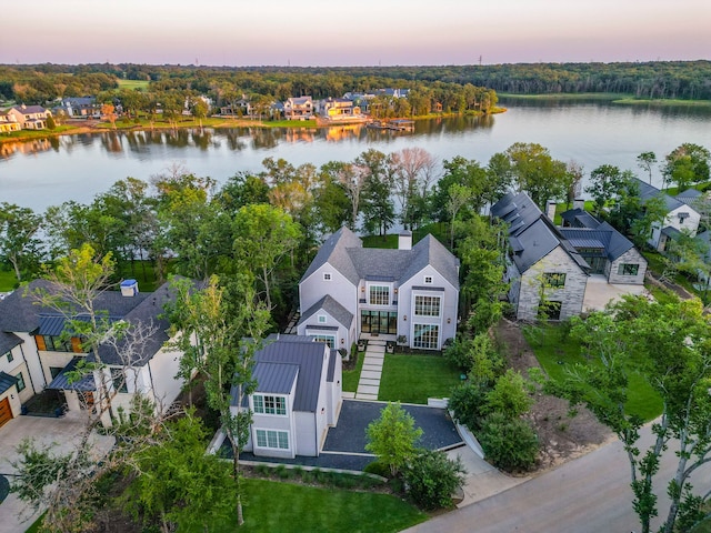 aerial view at dusk with a water view