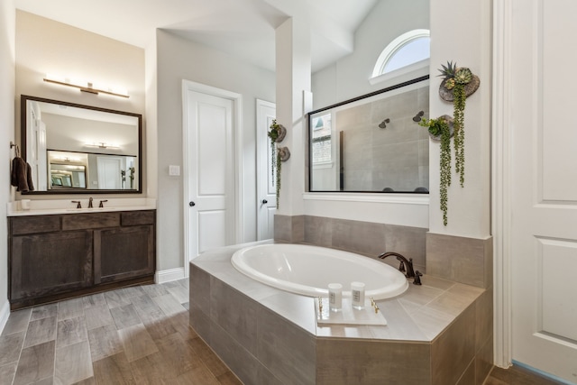 bathroom featuring vanity, separate shower and tub, and wood-type flooring