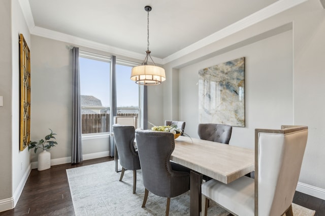 dining space with ornamental molding and dark hardwood / wood-style flooring