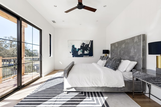 bedroom featuring wood finished floors, a ceiling fan, baseboards, visible vents, and access to exterior