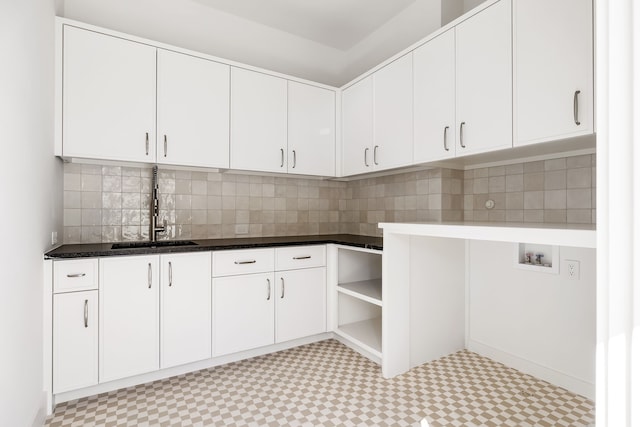 laundry area with washer hookup, cabinet space, a sink, and light floors