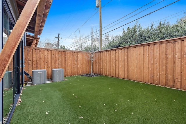 view of yard featuring a fenced backyard and cooling unit