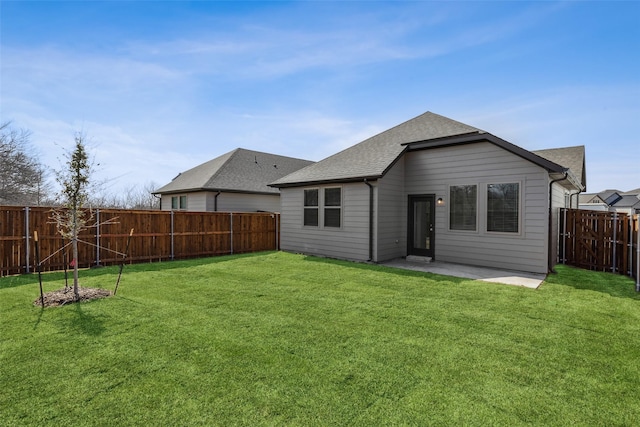 rear view of property featuring a patio and a lawn